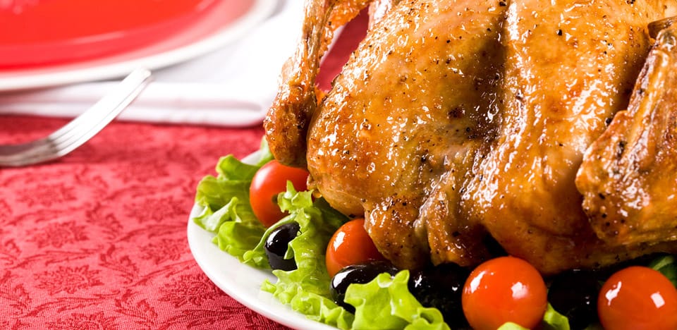 deep fryed turkey served with salad tomatoes and olives